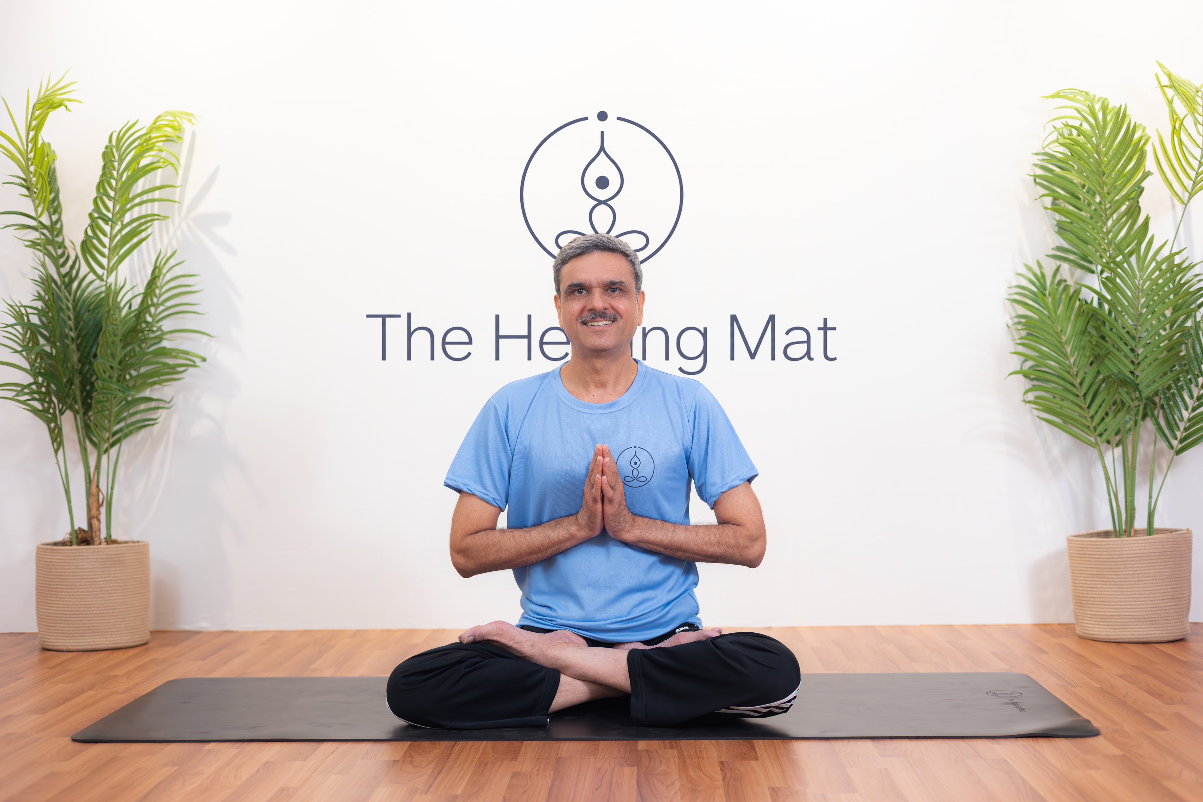 Yoga practitioner seated in namaste at The Healing Mat studio